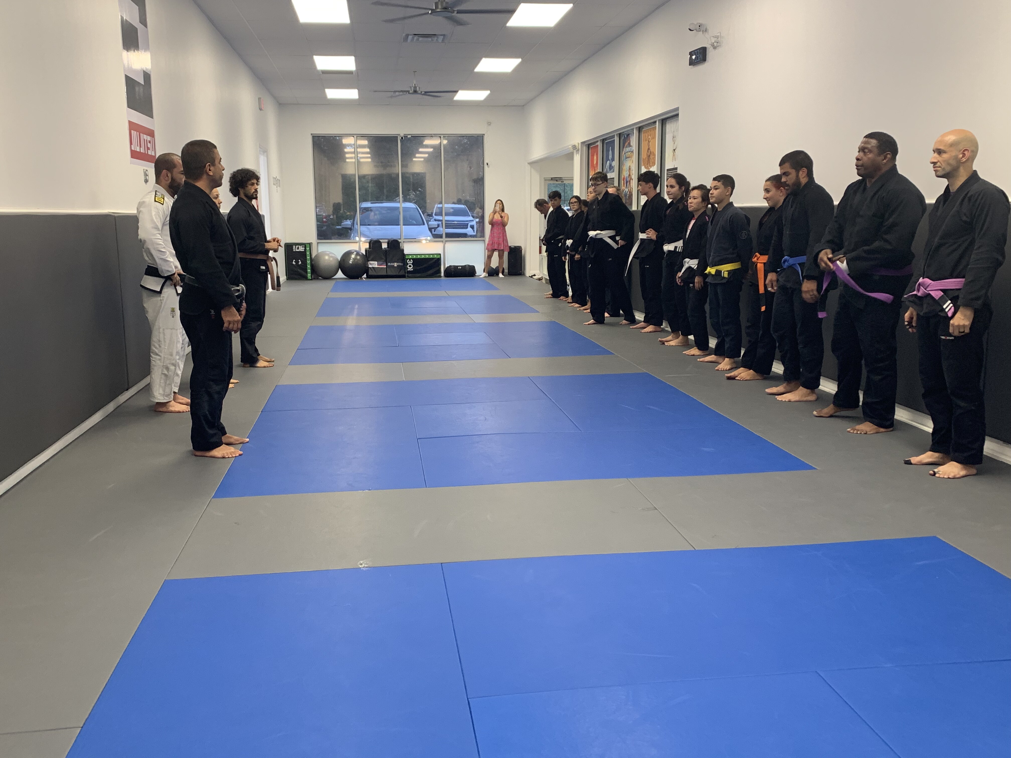 Adults class lined up on the mats before training